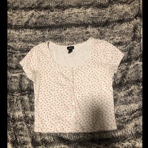 floral tee. not cropped. lightly worn. buttons work
